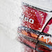 Close-up of the rear side of a red vehicle covered in white foam, with the chrome 'M60' badge visible on the trunk.
